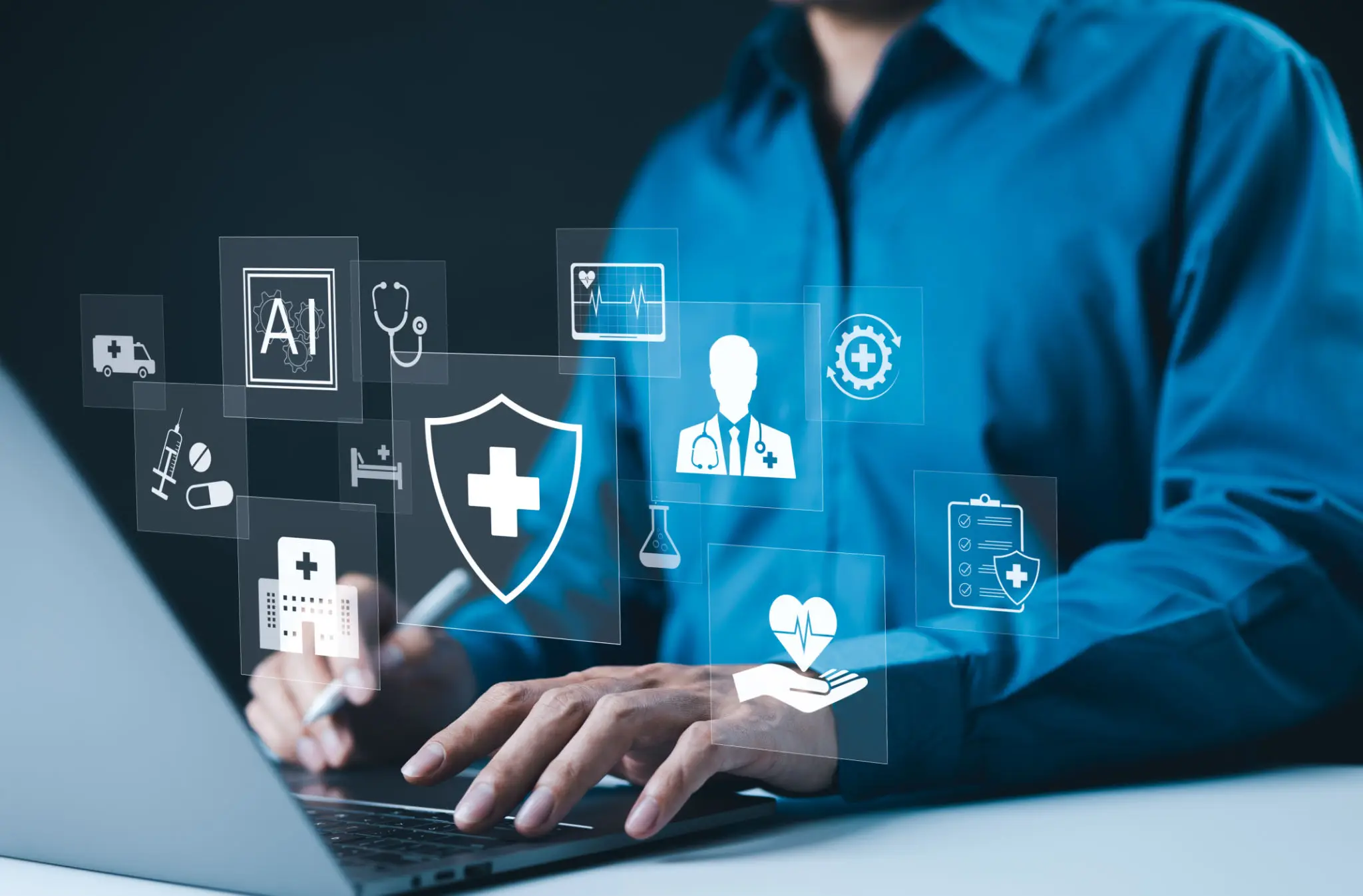 Hands using laptop with floating healthcare icons
