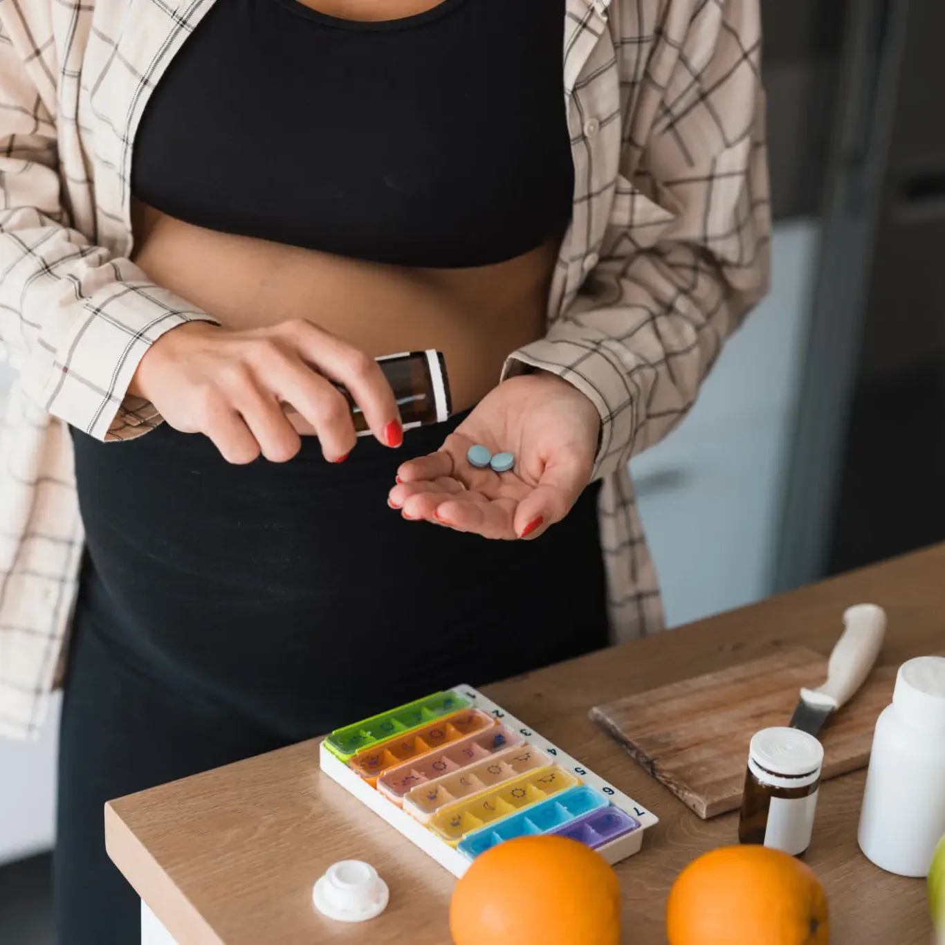 Person pouring blue pills into palm